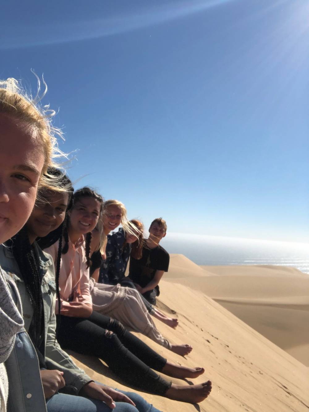 Students sitting on a dune slope